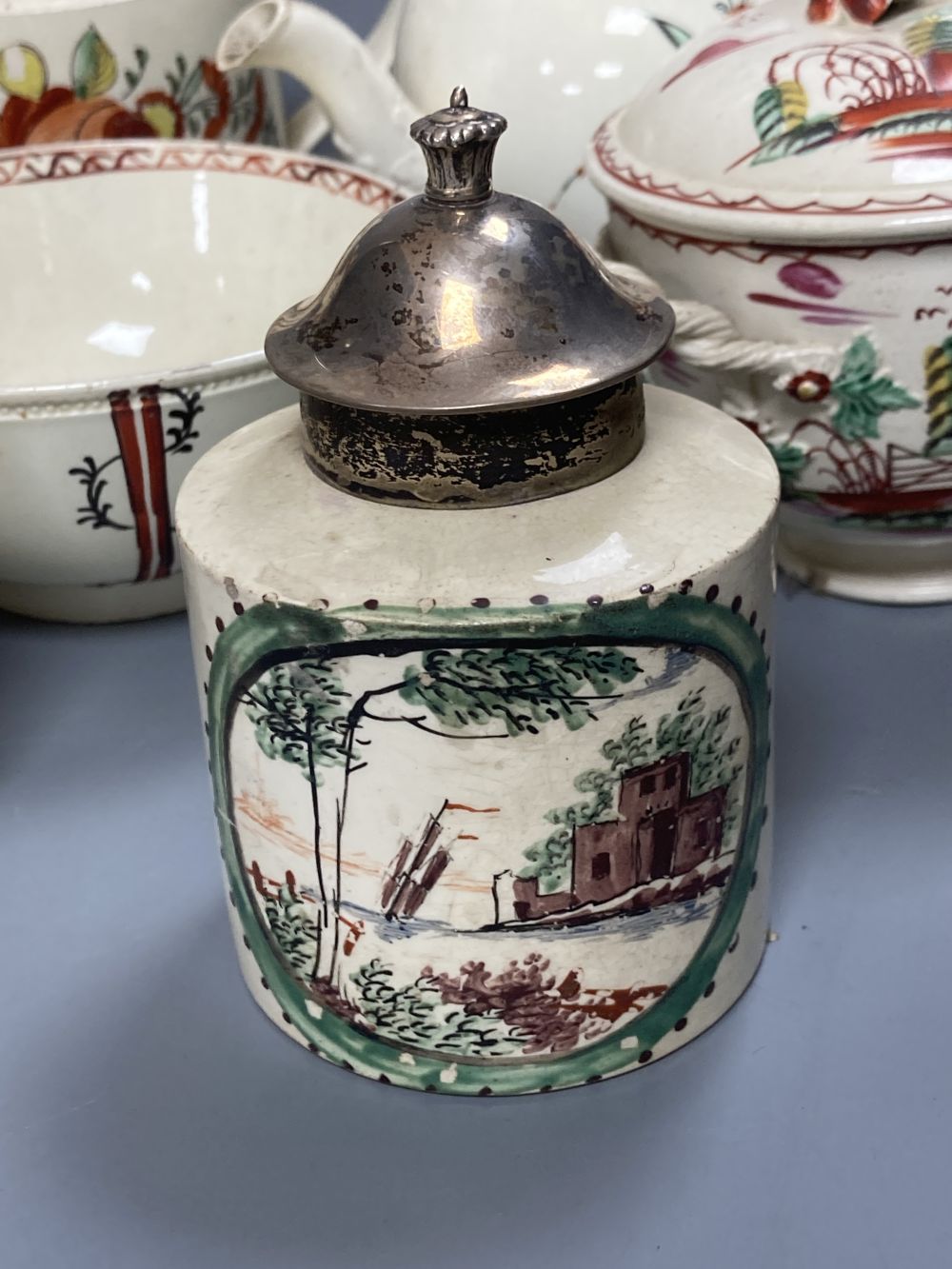 A collection of nine pieces of late 18th century creamware, including bullet-shaped teapot, 11cm high and four tea canisters with silve